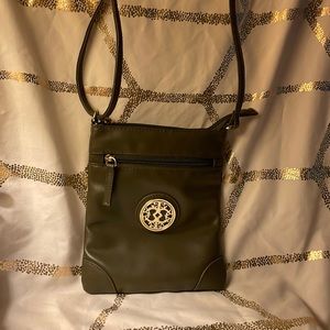 Avocado crossbody purse with gold scroll emblem on front
